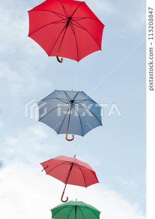 Many colorful umbrellas on the open sky Many colorful umbrellas on the open sky 113208847