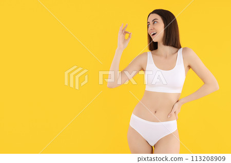 Slim girl in underwear, on a light background. Slim girl in underwear, on a light background. 113208909