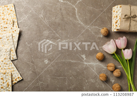 Matzo, nuts and flowers on gray background, space for text 113208987