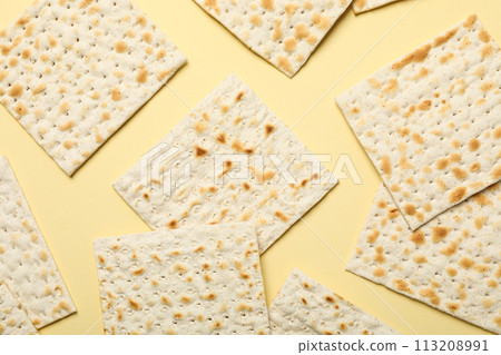 Matzo on light yellow background, top view 113208991
