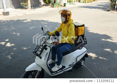Courier riding motorbike when delivering orders Courier riding motorbike when delivering orders 113209112