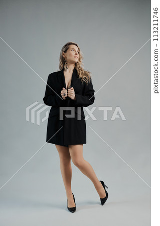 Beautiful woman with a long hair in a black jacket Beautiful woman with a long hair in a black jacket 113211746