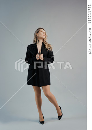 Beautiful woman with a long hair in a black jacket 113211751