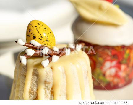 Traditional Easter cottage cheese dessert Paskha decorated with quail eggs and chocolate willow on tabletop background. Modern Orthodox Easter background with two mini cottage curd desserts Paskha 113211773