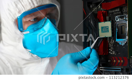Male engineer install microprocessor in fast computer Male engineer install microprocessor in fast computer 113212376
