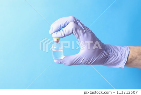 Doctor holding glass ampoule with medicine in rubber gloves closeup 113212507