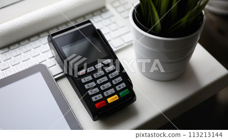 Mobile POS payment terminal lie on white table 113213144