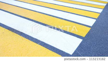 Closeup of white and yellow stripes on gray asphalt background 113213182