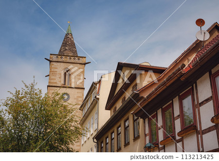spring trip to Europe. Travel and German sightseeing locations. interesting ancient towers and facades of medieval houses somewhere in Erfurt city 113213425