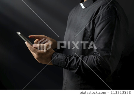 Portrait of a pastor using a mobile phone 113213558