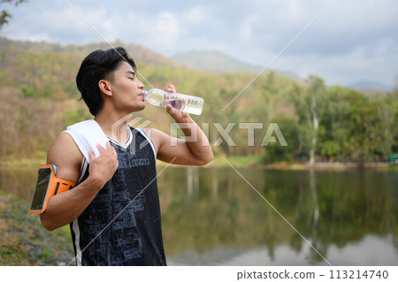 Shot of male runner resting and drinking water from a bottle for hydration after exercising Shot of male runner resting and drinking water from a bottle for hydration after exercising 113214740