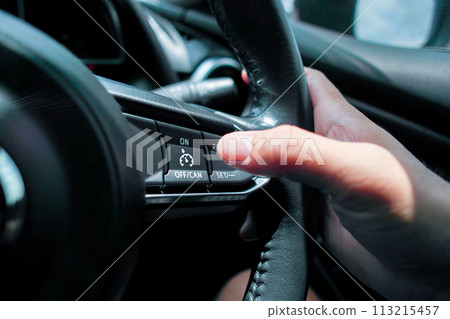 Automotive cruise control system on the steering wheel in a car  113215457
