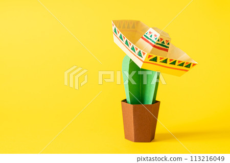 Cinco de Mayo concept - paper craft cactus in sombrero on solid color background Cinco de Mayo concept - paper craft cactus in sombrero on solid color background 113216049
