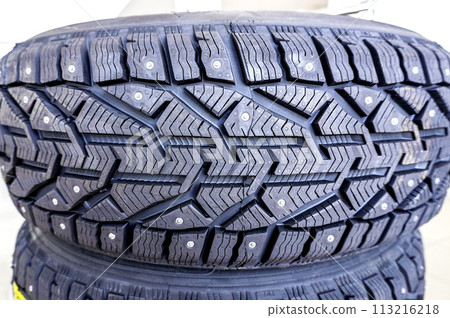 Winter vehicle tires stacked up for sale in the store 113216218