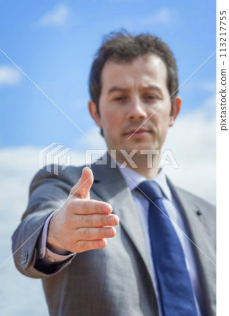 Business man with his open hand ready for seal a deal Business man with his open hand ready for seal a deal 113217755