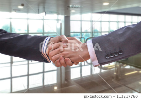 Business handshake for a closing deal Business handshake for a closing deal 113217760