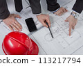 Above view of architects hands revising a house project 113217794