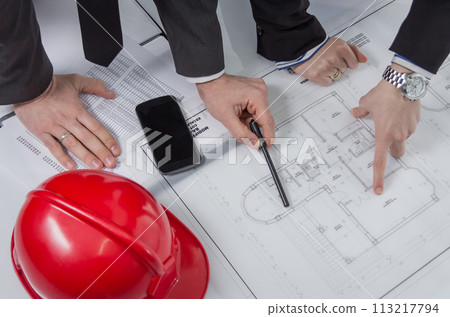 Above view of architects hands revising a house project 113217794