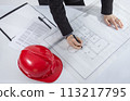 Above view of architects hands revising a house project 113217795