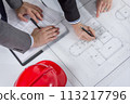 Above view of architects hands revising a house project 113217796
