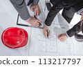 Above view of architects hands revising a house project 113217797