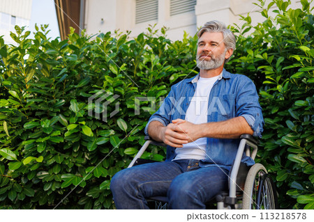 Disabled Man Enjoying Nature in Wheelchair Disabled Man Enjoying Nature in Wheelchair 113218578