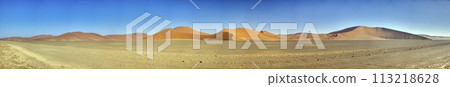 Panoramic picture of the red dunes of the Namib Desert in Namibia against a blue sky in the evening light Panoramic picture of the red dunes of the Namib Desert in Namibia against a blue sky in the evening light 113218628