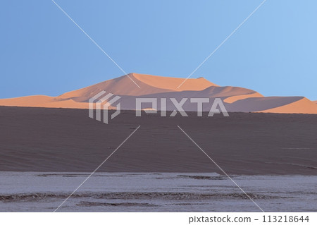 Panoramic picture of the red dunes of the Namib Desert in Namibia against a blue sky in the evening light Panoramic picture of the red dunes of the Namib Desert in Namibia against a blue sky in the evening light 113218644