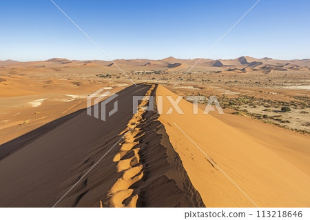 Panoramic picture from the top of the Bag Daddy Dune in Sossusvlei of the Namib Desert landscape against a blue sky 113218646