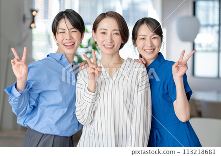 Three women making peace signs Three women making peace signs 113218681