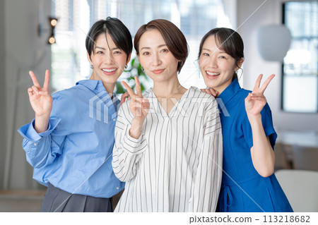 Three women making peace signs Three women making peace signs 113218682