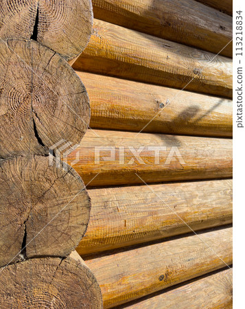 Logs of a wooden house in close-up on a sunny day, a bathhouse, the hut Logs of a wooden house in close-up on a sunny day, a bathhouse, the hut 113218834