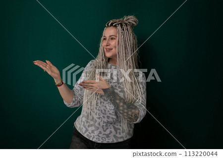 Woman With Long Blonde Hair in Front of Green Wall Woman With Long Blonde Hair in Front of Green Wall 113220044