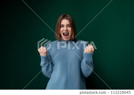 Woman in Blue Sweater Making Funny Face Woman in Blue Sweater Making Funny Face 113220045