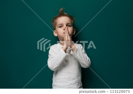 Young Boy Covering Mouth With Hands Young Boy Covering Mouth With Hands 113220073