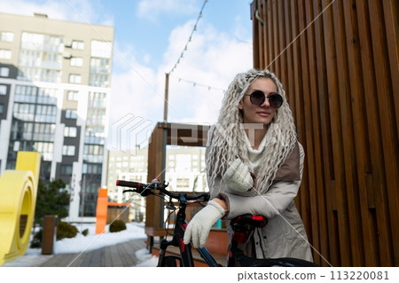 Woman in White Coat and Sunglasses Standing Next to Bike Woman in White Coat and Sunglasses Standing Next to Bike 113220081