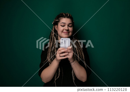 Woman With Dreadlocks Holding Cell Phone 113220128