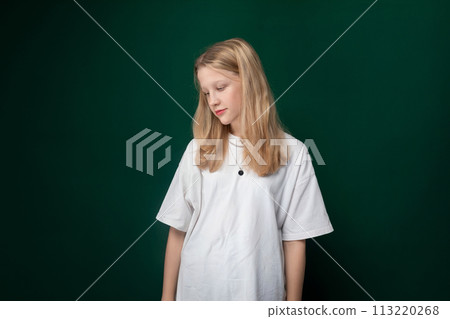 Woman Standing in Front of Green Wall 113220268