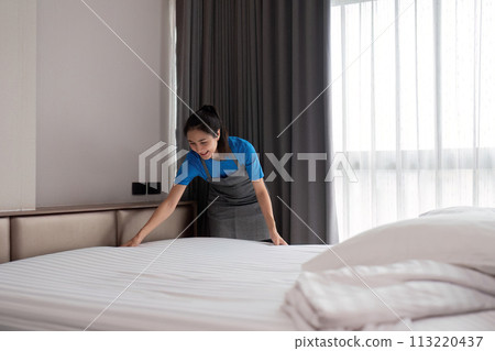 A woman asian staff cleaning service, tool and bucket for work. a young female cleaner with products to clean a bedroom A woman asian staff cleaning service, tool and bucket for work. a young female cleaner with products to clean a bedroom 113220437