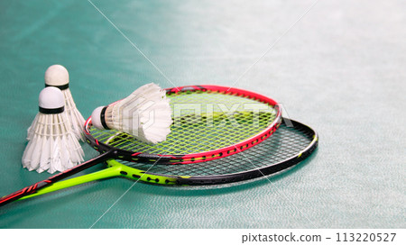 White badminton shuttlecocks and badminton rackets on green floor indoor badminton court soft and selective focus on shuttlecocks and the rackets White badminton shuttlecocks and badminton rackets on green floor indoor badminton court soft and selective focus on shuttlecocks and the rackets 113220527