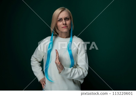 Woman With Blue Hair Standing in Front of Green Background Woman With Blue Hair Standing in Front of Green Background 113220601