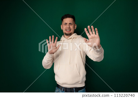 Man in White Hoodie Holding Hands Up 113220740