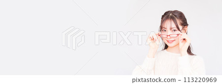 A young woman at an ophthalmologist takes off her glasses for a vision test [ Image of LASIK ] 113220969