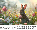 Easter cute little bunny among spring flower meadow. Easter holiday 113221257