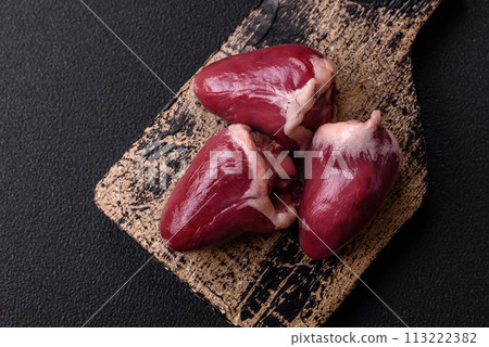 Raw turkey or chicken hearts with salt and spices Raw turkey or chicken hearts with salt and spices 113222382