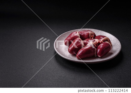 Raw turkey or chicken hearts with salt and spices 113222414