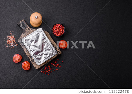 Rectangular plastic box with yogurt or cheese hermetically sealed with a foil lid 113222478