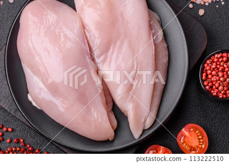 Fresh chicken fillet on a dark concrete table with spices and herbs 113222510