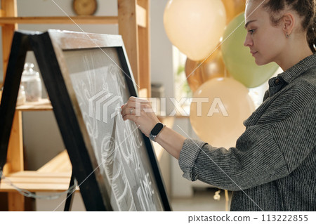 Drawing advert with chalk on blackboard 113222855