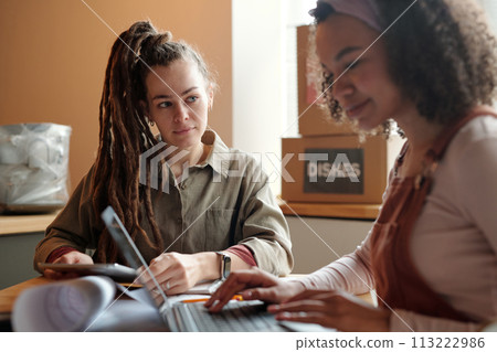 Woman with tablet looking at colleague Woman with tablet looking at colleague 113222986